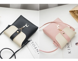 Detail view of mini crossbody bags with deer charm and contrast color faux leather design