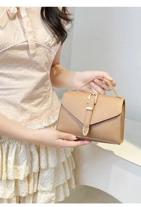 Mini brown leather crossbody bag with top handle and gold horseshoe buckle detail