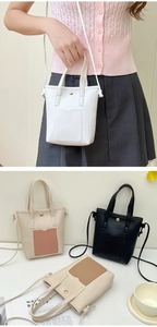 Detail of minimalist bucket bag showing front pocket and metal magnetic closure