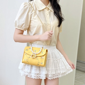 Yellow floral embroidery crossbody bag with pearl handle and golden chain strap