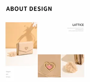 Detail of cream trifold wallet with metallic heart logo and matching pompom charm