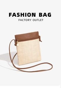 Detail of straw crossbody phone bag with brown faux leather trim and golden metal zipper