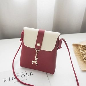Chic two-tone phone purse in burgundy and cream with a golden deer charm detail