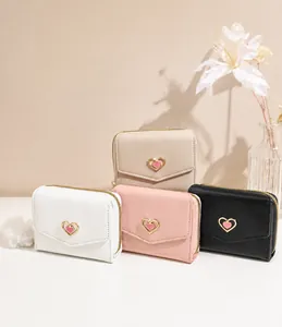 Detailed view of trifold heart-lock wallets in white, pink, black, and beige colors