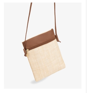 Close-up of woven straw texture and premium brown leather patchwork on phone crossbody bag