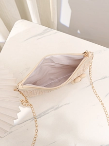 Détails de l'intérieur d'un sac bandoulière en paille avec chaîne et fermeture éclair