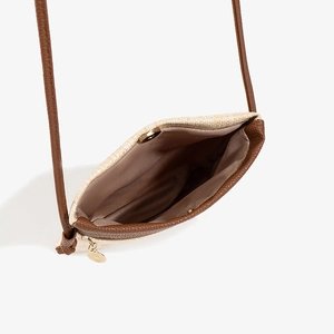 Minimalist straw woven crossbody phone bag with brown leather trim and golden zipper detail