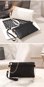 Close-up of diamond quilted pattern handbag with premium gold chain and wrist strap detail