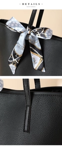 Detail der Leder-Tragetasche mit Lychee-Muster, dekorativem Seidenschal und verstärkten Nähten