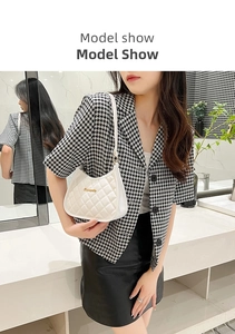 Chic white quilted faux leather underarm bag with gold logo on houndstooth blazer