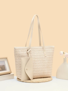 Detail view of woven herringbone straw tote bag with matching leather envelope pouch