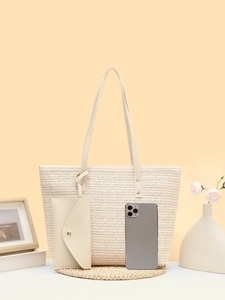 Detail of cream woven tote bag set with V-shaped texture and matching small pouch