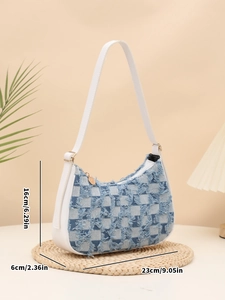 Detail of blue checkerboard denim shoulder bag with fringed edges and gold hardware