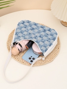 Detail of checkered denim hobo bag interior with phone, umbrella and cosmetics