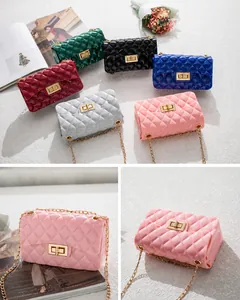 Close-up of quilted jelly cross-body bag with golden twist lock and metal chain strap