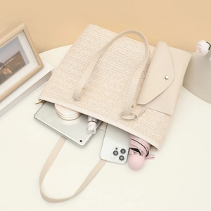 Cream woven tote bag with leather straps showing spacious interior for tablet and essentials
