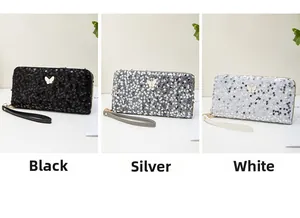 Portefeuilles brillants en noir, argent et blanc avec boucles papillon dorées