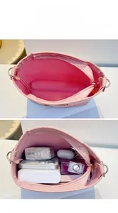 Detailed interior of the pink bucket bag showing large capacity for daily essentials