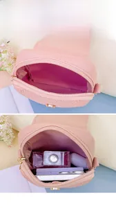 Detail of pink faux leather crossbody bag showing inner storage capacity and texture