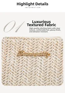 Detail of woven straw bag texture with elegant gold metal Suncity logo and V-stitch pattern