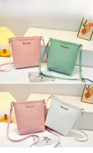 Detailed view of women's embossed bucket bags in pink, mint green and white finishes