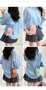 Detail of sweet phone crossbody bag with cat ear metal ring and pearl tassel accents