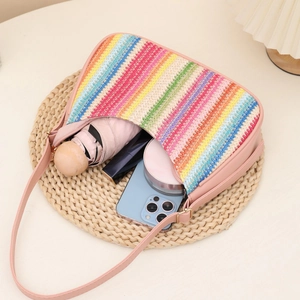 Rainbow woven crescent armpit bag with pink straps showing spacious internal storage