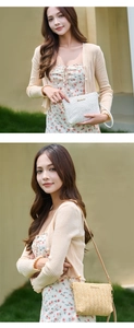 Close-up of woven straw handbag with striped texture and gold logo in white and beige