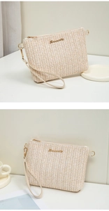 Detail of woven straw clutch with gold logo, metal zipper and minimalist PU wristlet