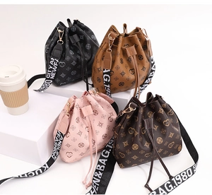Selection of four drawstring bucket bags with textured patterns and wide fabric straps