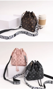 Three bucket bags in brown, pink, and black monogram with wide lettered straps