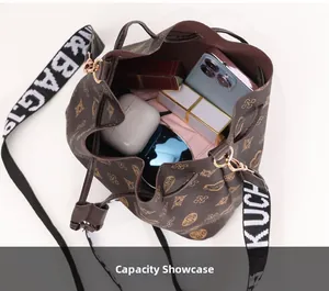 Top view of drawstring bucket bag showing internal capacity with phone and cosmetics