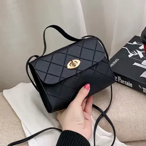 Classic black quilted handbag with gold twist-lock and top handle for women