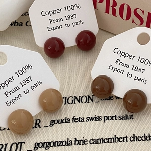 Three pairs of enamel ball stud earrings in red and brown colors on French-style display cards