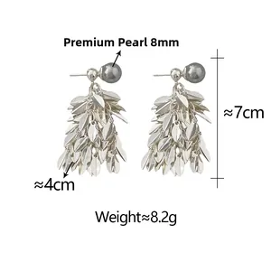 Detail view of leaf tassel earrings with 8mm dark pearl and size measurements