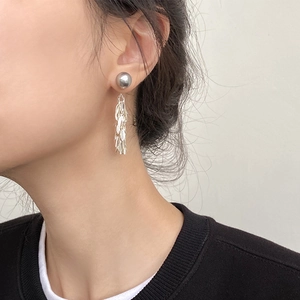Elegant silver leaf tassel earrings worn by model showing a stylish minimalist design
