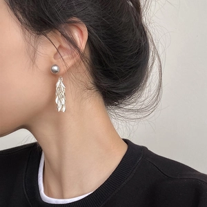 Silver leaf tassel earrings shown on model with minimalist metallic fringe design