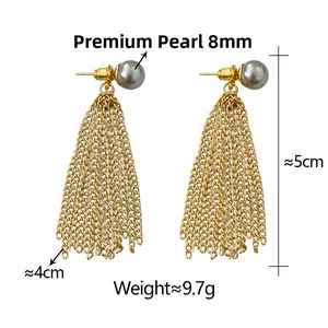 Detailed close-up of long gold fringe earrings with 8mm grey pearls and chain tassels