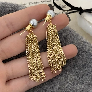 Elegant long golden tassel earrings with grey round pearls for evening wear style