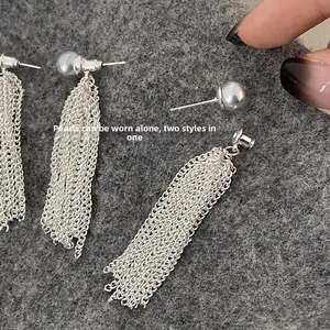 Detail of silver tassel earrings with detachable pearls for a dual-wear versatile style