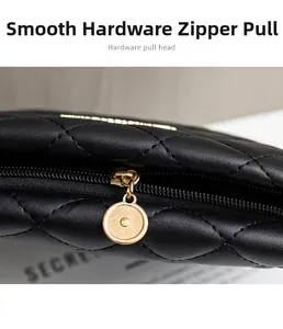 Detail of black quilted leather bucket bag featuring a gold round metallic zipper head
