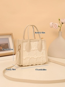 Detailed view of cream ruffled mini handbag with dimensions 17x14x7cm and top handle