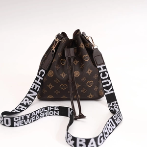 Deep brown drawstring bucket bag with floral monogram pattern and wide textile strap