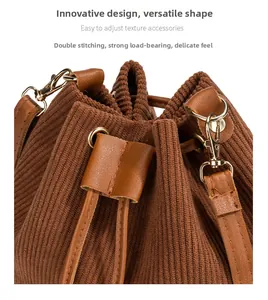 Detailed view of drawstring closure and gold hardware on brown corduroy bucket bag