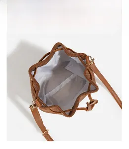 Top view of brown corduroy bucket bag showing spacious interior and drawstring closure