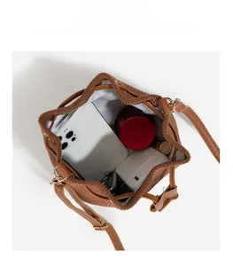 Macro view of corduroy bucket bag interior showcasing spacious storage and white lining
