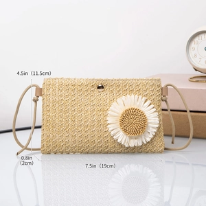 Woven straw crossbody bag with daisy flower detail and dimensions 19cm x 11.5cm