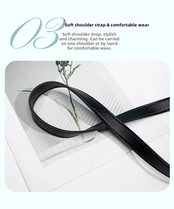 Detail of soft black leather shoulder strap with fine stitching and flexible texture