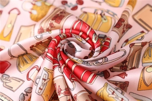 Detail of pink satin scarf showing vintage handbag prints and smooth silk texture