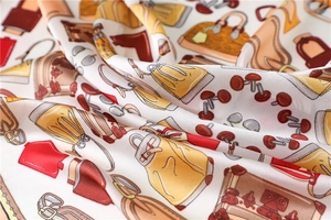 Macro view of luxurious faux silk scarf with elegant handbag and accessory patterns